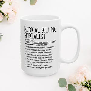 May include: White ceramic mug with the text "MEDICAL BILLING SPECIALIST" in black. The mug includes a definition and a list of job duties. The mug has a large handle and is surrounded by flowers.