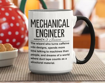 May include: White ceramic mug with a black handle and black rim. The mug has a black graphic that reads "MECHANICAL ENGINEER noun(n.) Jessica The wizard who turns caffeine into designs, spends more time talking to machines than people, and dreams of a world where duct tape counts as a structural material."