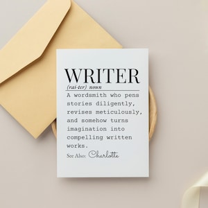 May include: A white card with the definition of "WRITER" in black text, including the pronunciation and a description of the profession. The card is accompanied by a tan envelope.