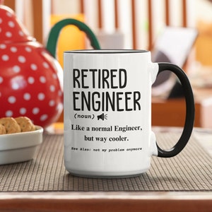 May include: White ceramic coffee mug with a black handle and black rim. The mug has black text that reads "Retired Engineer (noun) Like a normal Engineer, but way cooler. See Also: not my problem anymore."