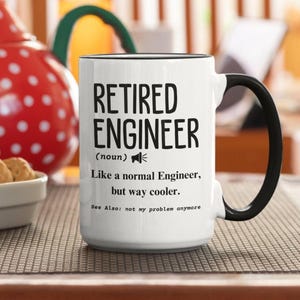 May include: A white ceramic mug with a black handle and rim, featuring black text that reads: RETIRED ENGINEER (noun) Like a normal Engineer, but way cooler. See Also: not my problem anymore. The mug has a megaphone icon next to the word noun.