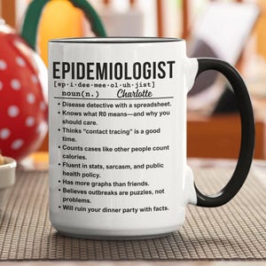 May include: White ceramic mug with a black handle and rim. The mug features the definition of "Epidemiologist" with humorous bullet points. The name "Charlotte" is printed below the word "noun".