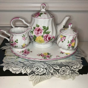 4 pc. Porcelain Teapot serving set with Teapot, sugar, creamer and serving tray - Pink and yellow roses