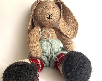 Knitted hare in blue pants. Handmade soft toy. Cute home decoration.