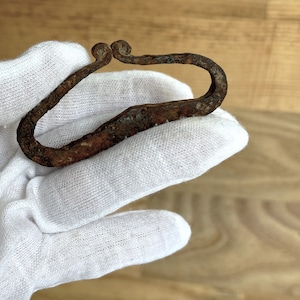 An ancient artifact for making fire. Viking lighter for fire 9th-12th centuries. Viking iron tools. Iron lighter.