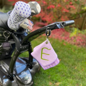 Golf ball, club cleaning towel with retractable badge reel with carabiner belt clip and key ring..