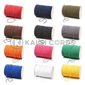 May include: Twelve spools of elastic cord in various colours, including red, navy blue, olive green, brown, black, grey, orange, pink, green, blue, white, and yellow.
