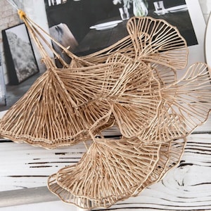 May include: A bouquet of gold-coloured ginkgo leaves, each leaf is intricately detailed with a delicate wire frame.