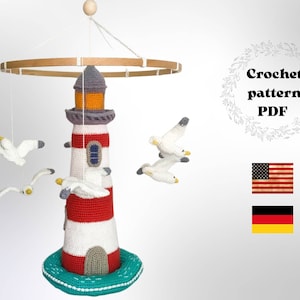 May include: Crochet pattern PDF for a lighthouse and seagull mobile. The mobile features a red and white striped lighthouse with a gray roof and a green base. There are four white seagulls flying around the lighthouse. The pattern is available in English and German.