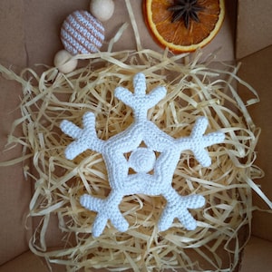 May include: A white crocheted snowflake ornament in a box filled with shredded paper.