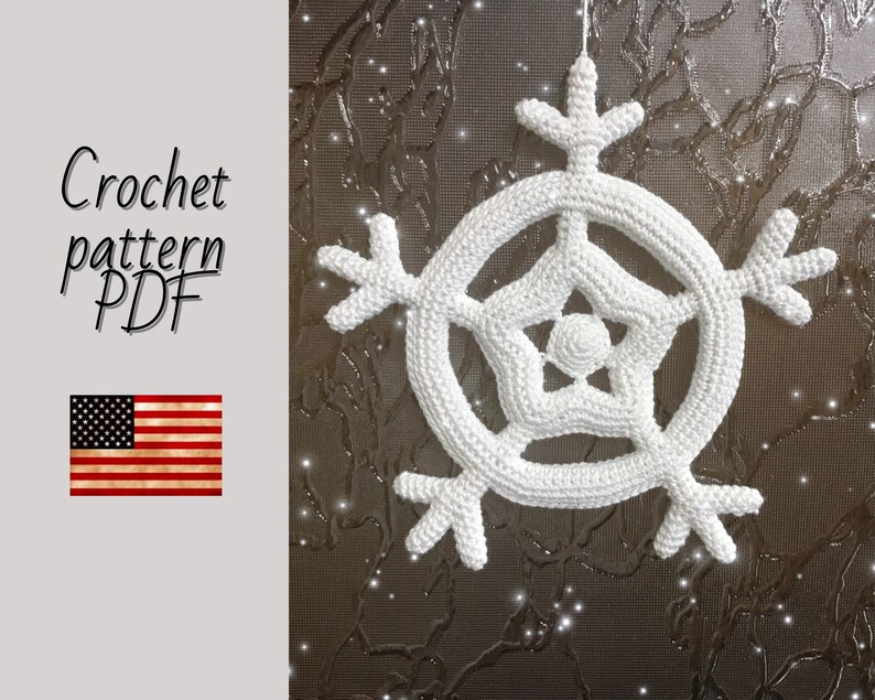 May include: White crochet snowflake ornament with a five-pointed star in the center. The snowflake is hanging from a string against a brown background. Crochet pattern PDF.