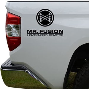 May include: A white pickup truck with a black decal of a circle with a cross inside and the text "MR. FUSION HOME ENERGY REACTOR" on the side.