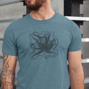 May include: A teal blue t-shirt with a vintage illustration of an octopus printed on the front.