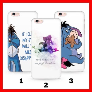 May include: Three different phone cases featuring the cartoon character Eeyore from Winnie the Pooh. The first case shows Eeyore with a sad expression and the text "If I close my eyes, the world will disappear". The second case shows a watercolour-style image of Eeyore walking with the text "Weeds are flowers too, once you get to know them". The third case shows Eeyore sitting with a teddy bear and a pink bow.