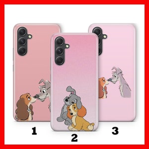 May include: Three pink phone cases with different images of Lady and the Tramp. The first case features Lady and Tramp kissing, the second case features Lady and Tramp with their puppies, and the third case features Lady and Tramp looking at each other.