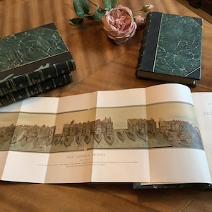 May include: A vintage, green, leather-bound book titled "A Short History of the English People" by J.R. Green, MA. The book is open to a page with an illustration of Old London Bridge.