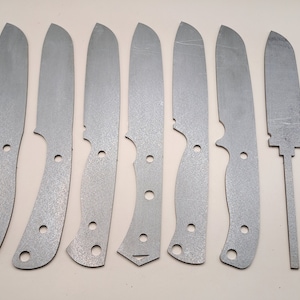 May include: Eight metal knife blanks, all with different shapes and sizes. The blanks are all silver in color and have a rough, textured surface.