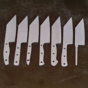 May include: Eight silver knife blanks with different blade shapes and handle designs. The blanks are laid out on a dark brown surface.