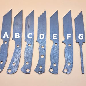 May include: Eight metal knife blades labelled A to G. The blades are all different shapes and sizes. They are arranged in a row from left to right.