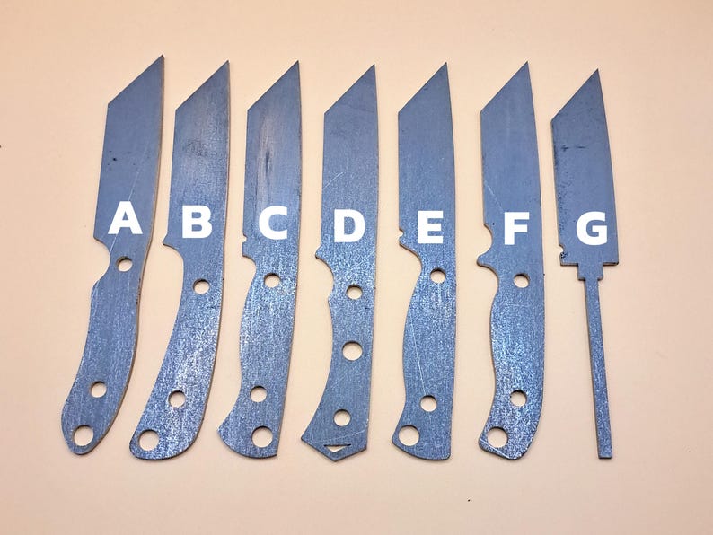 May include: Eight metal knife blades labelled A to G. The blades are all different shapes and sizes. They are arranged in a row from left to right.
