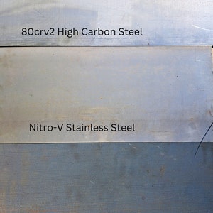 May include: Three metal samples labelled with their steel types: 80crv2 High Carbon Steel, Nitro-V Stainless Steel, and D2 Tool Steel.