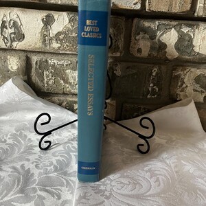May include: A blue hardcover book titled "Selected Essays" by Emerson. The book is part of the "Best Loved Classics" series.