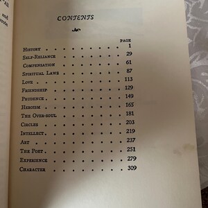 May include: A black and white book with the title "CONTENTS" and a list of chapters with page numbers. The chapters include "History", "Self-Reliance", "Compensation", "Spiritual Laws", "Love", "Friendship", "Prudence", "Heroism", "The Over-Soul", "Circles", "Intellect", "Art", "The Poet", "Experience", and "Character".