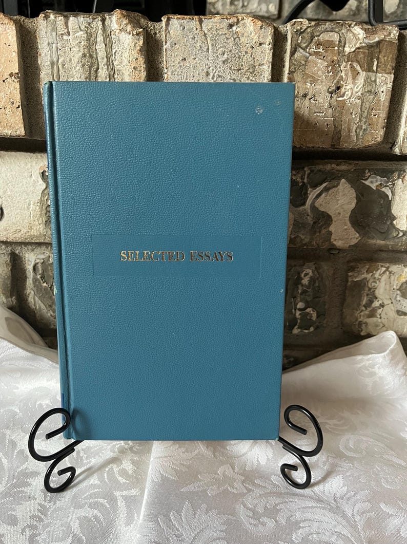May include: A teal blue hardcover book with the title "SELECTED ESSAYS" printed in silver on the front cover.