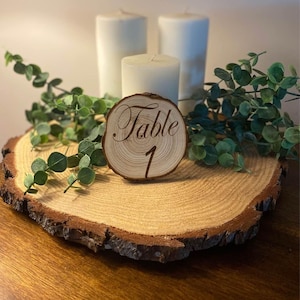 table numbers wood slice centerpiece set, dried eucalyptus for wedding, white candles for centerpieces, rustic wedding centerpieces for
