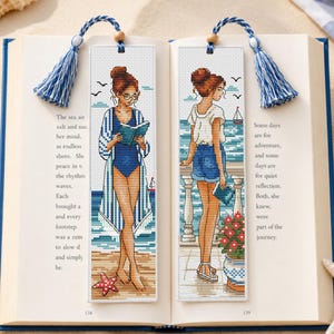Set di due schemi per punto croce "Ragazza che legge in riva al mare".
