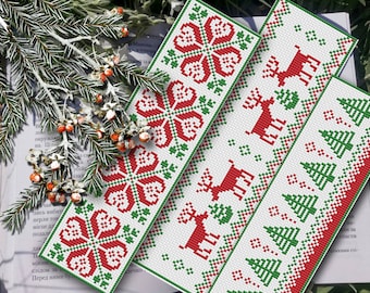 May include: Three red and green embroidered bookmarks with different designs. The first bookmark features a snowflake pattern, the second features a reindeer pattern, and the third features a Christmas tree pattern.