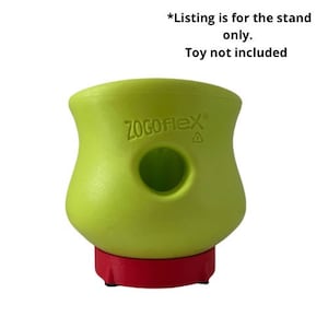 Puede incluir: Soporte de juguete para perro verde con el texto "ZOGOFLEX" en el lateral. El soporte tiene una base roja con tres patas.