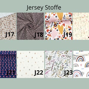 May include: A grid of eight fabric swatches labeled J17 through J24 under the heading Jersey Stoffe. Patterns include leopard prints, hearts, floral sprigs, sailboats, and rainbows in various colors like navy, white, pink, and brown.