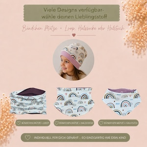 Könnte beinhalten: Eine Mütze mit rosa Bündchen und Regenbogenmuster, ein passender Loop-Schal und ein Halstuch. Der Text lautet: Viele Designs verfügbar-wähle deinen Lieblingsstoff, Bündchen Mütze + Loop, Halssocke oder Halstuch, INDIVIDUELL FÜR DICH GENÄHT – SO EINZIGARTIG WIE DEIN KIND.