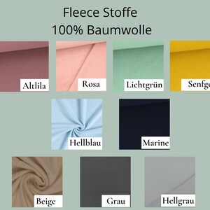 May include: A collection of fleece fabric swatches in nine colors labeled Altlila, Rosa, Lichtgr&uuml;n, Senfgelb, Hellblau, Marine, Beige, Grau, and Hellgrau. The text Fleece Stoffe 100% Baumwolle is displayed at the top of the color grid.