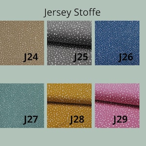 K&ouml;nnte beinhalten: Eine Sammlung von sechs Jersey-Stoffmustern mit der Bezeichnung J24 bis J29, jeweils mit einem wei&szlig;en Sprenkelmuster auf einfarbigem Hintergrund in Beige, Dunkelgrau, Blau, Petrol, Senfgelb und Pink. Der Text Jersey Stoffe steht oben.