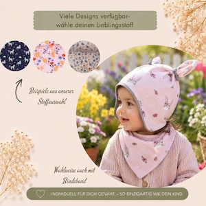 Könnte beinhalten: Eine hellrosa Babymütze mit Hasenohren und ein passendes dreieckiges Halstuch, beide mit Blumen- und Hasenmuster. Der Text umfasst 'Viele Designs verfügbar-wähle deinen Lieblingsstoff', 'Beispiele aus unserer Stoffauswahl', 'Wahlweise auch mit Bindeband' und 'INDIVIDUELL FÜR DICH GENÄHT – SO EINZIGARTIG WIE DEIN KIND'.