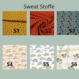 May include: Six fabric swatches labeled S1 through S6 under the heading Sweat Stoffe. S1 is mustard with black dashes, S2 is rust with white dashes, S3 is blue with multicolored dots, S4 and S5 feature rainbow patterns, and S6 has green leaves.