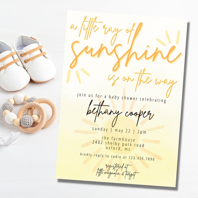 May include: A yellow and white baby shower invitation with the text "a little ray of sunshine is on the way" and a sun graphic. The invitation also includes the name "bethany cooper", the date "sunday | may 22 | 2pm", the location "the farmhouse 2402 shelby park road oxford, ms", and the text "kindly reply to sadie at 123.456.7890" and "registered at little magnolia & target".