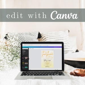 May include: A laptop computer displaying a Canva design for a baby shower invitation. The invitation features a yellow sun with the text "A little ray of sunshine is on the way" and the name "Brittany Cooper". The laptop is on a bed with white bedding and pillows.