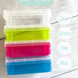 Op de afbeelding: Stapel van vier doorzichtige plastic opbergcontainers met deksels. De containers zijn in de kleuren helder, groen, roze en blauw. De tekst "Color Options" staat boven de containers.
