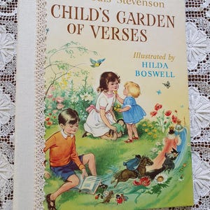 Op de afbeelding: Een vintage kinderboek getiteld "Kindertuin van Verzen" van Robert Louis Stevenson, geïllustreerd door Hilda Boswell. De omslag toont een kleurrijke illustratie van kinderen die in een tuin spelen met bloemen, vlinders en een kleine vogel.