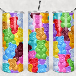 May include: A stainless steel tumbler with a colorful gummy bear pattern. The tumbler is 20 ounces and has a straw.