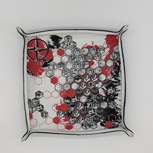 May include: White fabric dice tray with black trim and a red and black design featuring a compass and hexagonal patterns.