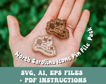 May include: Two wooden laser cut pins featuring a bird and floral design with the text "NORTH CAROLINA". The pins are held in a hand against a green background. The text "North Carolina Icons Pin File Pack" and "SVG, AI, EPS FILES + PDF INSTRUCTIONS" are also visible.