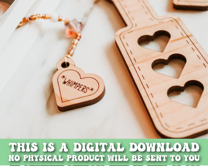 May include: Wooden paddle with three heart cutouts and a heart-shaped tag that says "*WHIMPERS*". The tag is attached to a beaded strand. The text at the bottom says "THIS IS A DIGITAL DOWNLOAD NO PHYSICAL PRODUCT WILL BE SENT TO YOU".