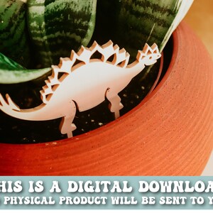 May include: White wooden dinosaur cutout with a spiky back, placed in a terracotta pot with a green plant. The text "THIS IS A DIGITAL DOWNLOAD NO PHYSICAL PRODUCT WILL BE SENT TO YOU" is at the bottom of the image.
