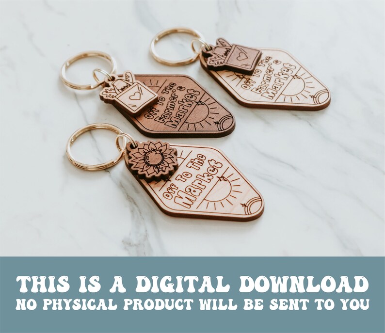 May include: Three wooden keychains with a diamond shape and a gold key ring. Each keychain has a different design. One has a sunflower, another has a small mailbox with a heart, and the third has a sun. All three keychains have the text "Off to the Market" on them.