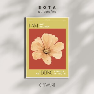 May include: A framed art print with a floral design. The print features a large, light orange flower centered on a red background, with the text "I AM NOT BROKEN" and "I AM BEING REBUILT IN TRUTH". The print has a yellow border and the word "EPIVANT" at the bottom.