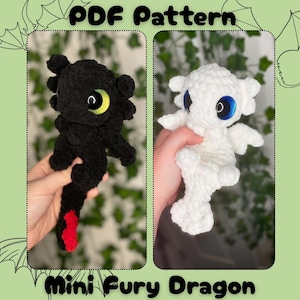 May include: A PDF pattern for crocheted Mini Fury Dragons. The image shows two finished dragons: one black with yellow eyes and red accents, and one white with blue eyes. The text "PDF Pattern" and "Mini Fury Dragon" are displayed.
